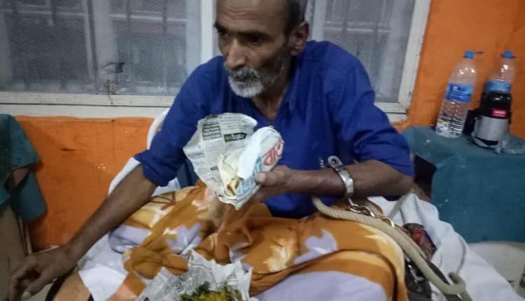 Detainee Krishna Sarkar in Hospital bed with a handcuffs photo- Hussain Ahmed Madani 2